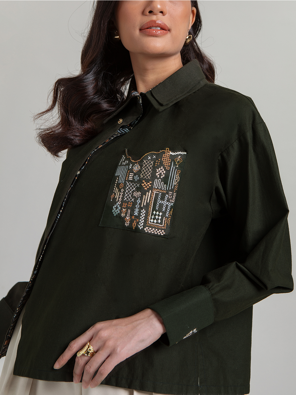DISKON 15%. Atasan wanita lengan panjang premium. Kemeja kasual berpotongan longgar dengan plaket asimetris dan detail bordir saku yang unik.